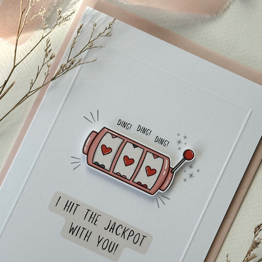 Card with a slot machine illustration and text 'I hit the jackpot with you!' on a light background.